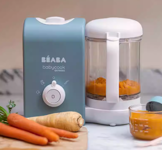 Beaba Babycook Express in action, steaming and blending fresh carrots into smooth baby puree—demonstrating fast, easy, and nutritious homemade baby food preparation.