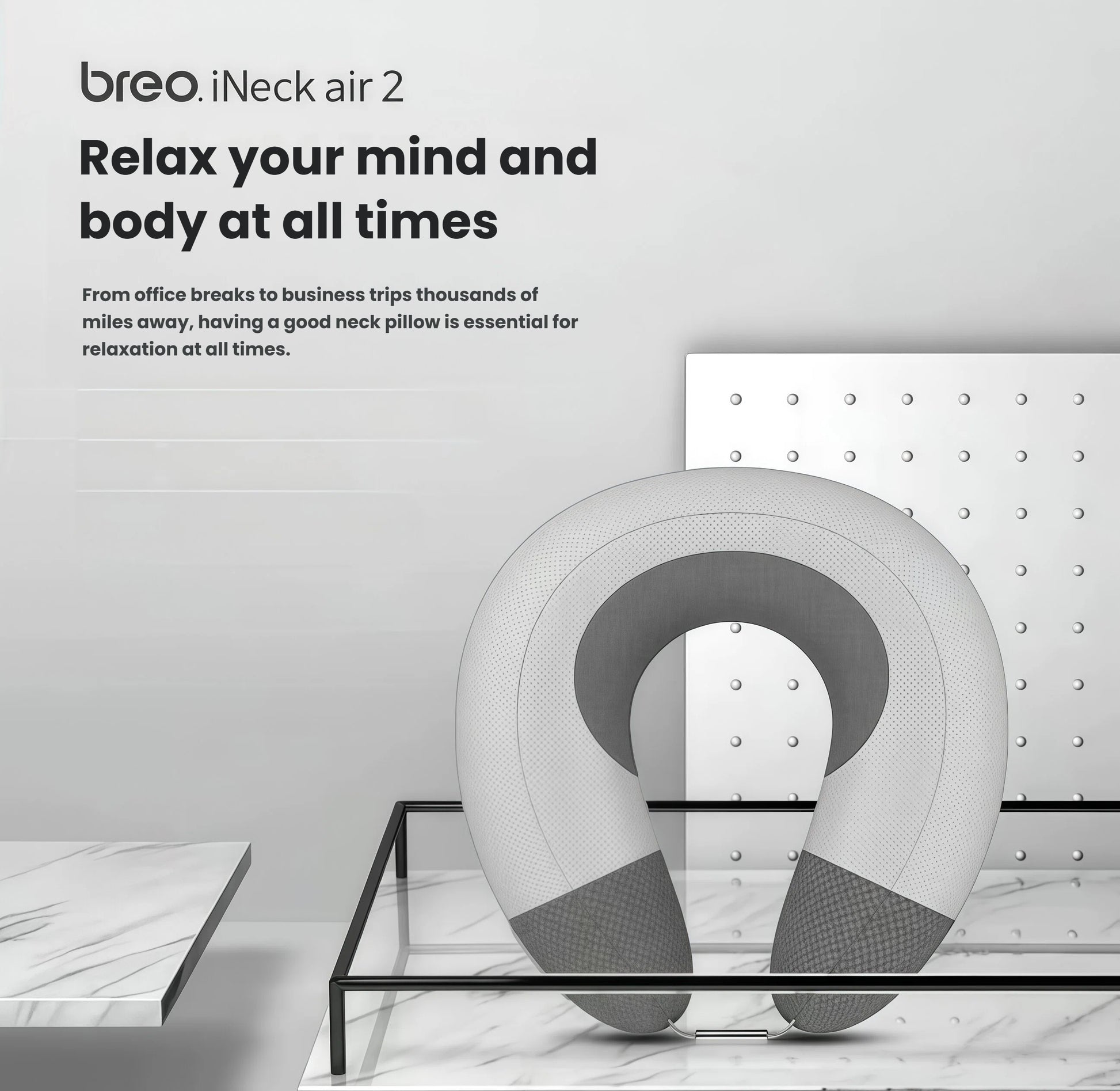 The Breo iNeck Air 2 inflatable neck massager displayed on a modern glass stand. Designed for relaxation during office breaks or long business trips, it combines comfort and smart wellness technology.