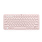 Overhead shot of the pastel-pink Logitech K380 Bluetooth keyboard, showcasing its chic round-key layout and compact form factor ideal for mobile workspaces.