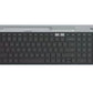 Overhead shot of the graphite Logitech K580 slim wireless keyboard, featuring a built-in phone/tablet cradle, full-size layout with numeric keypad, and dual-connectivity indicators.