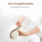 Two OSIM uMask eye massagers in white and navy blue displayed on a cozy bed with soft linens. The premium design combines comfort, style, and advanced eye care technology for daily use at home or travel.