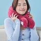 A woman wearing the red OSIM uSnooz massage wrap with Minnie Mouse faces around her neck, enjoying relaxation. The soft, ergonomic design supports the neck and shoulders comfortably.