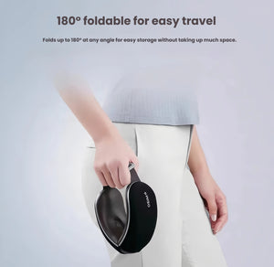 A person holding the folded OSIM uVision Air eye massager, showcasing its compact 180° foldable design. The lightweight black device fits easily into a bag or pocket, ideal for travel and on-the-go use.