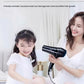 Mother drying her daughter’s hair with Philips DryCare Pro hairdryer at a safe, constant 57°C temperature—ideal for sensitive scalps and healthy hair care.