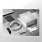Unboxing view of SKG G7 Pro foldable neck massager featuring sleek white device, compact remote control, USB-C charging cable, user manual, and premium SKG-branded box on a modern desk setup.