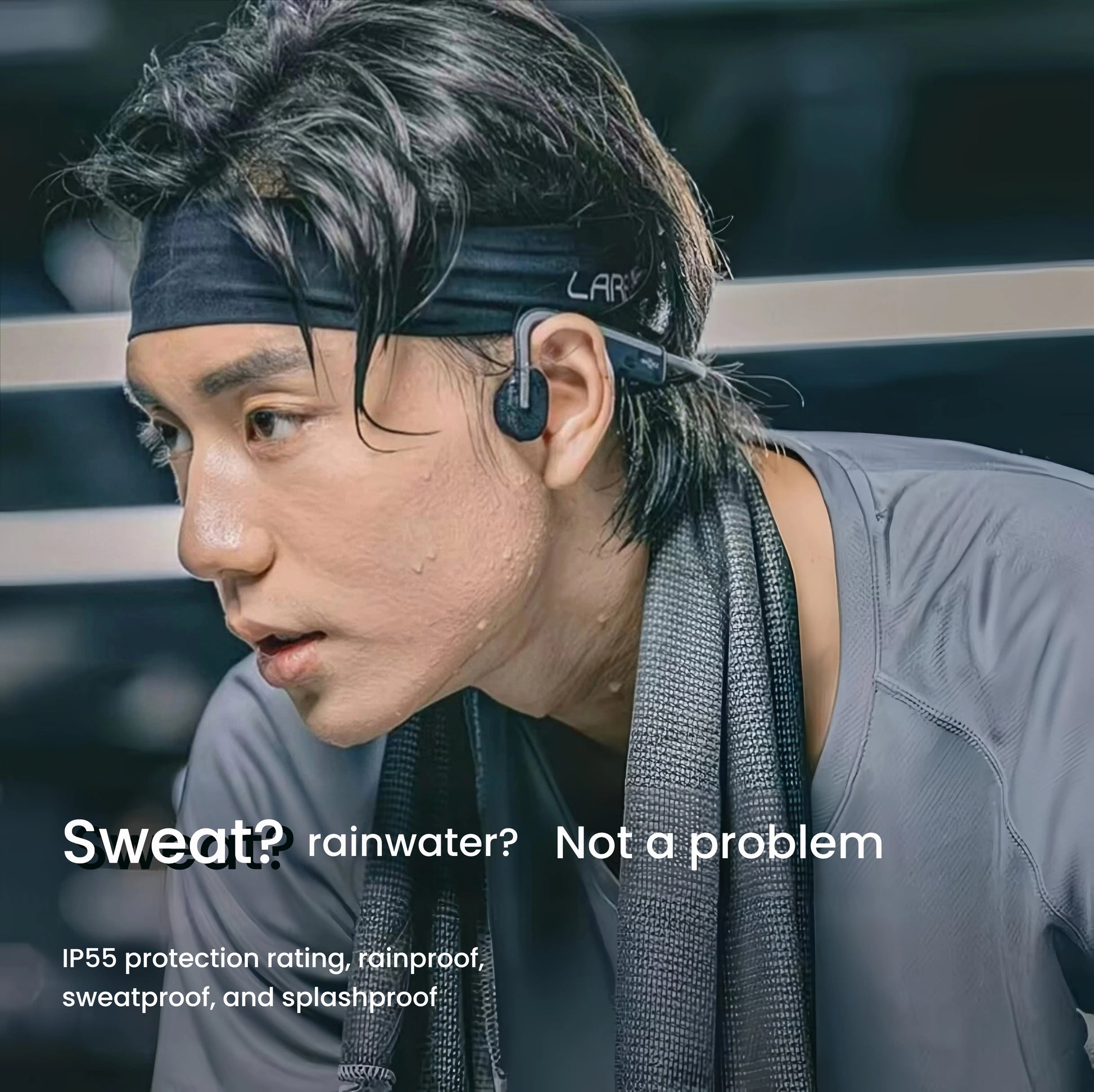Man wearing Shokz OpenMove headphones during intense workout — IP55-rated for sweatproof, rainproof, and splashproof performance in all weather conditions.