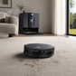 ECOVACS DEEBOT X12 robot vacuum cleaning carpet with station behind