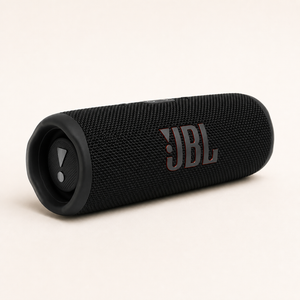 JBL Flip 6 black speaker showing the JBL logo on the front grille